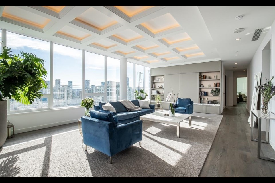 The living room of this $13 million condo listed for sale in Vancouver has huge views of the city.