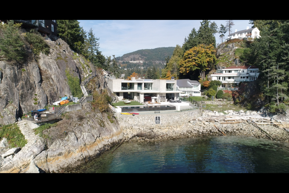 The property at 5340 Seaside Place in West Vancouver comes with access to 89 feet of shoreline, a theatre room, wine cellar and infinity pool.