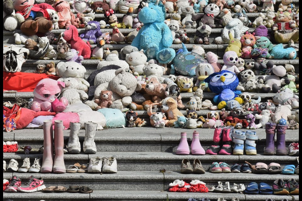 Toys and shoes cover steps at the 鶹ýӳArt Gallery as a memorial to the Indigenous children who died at Canadian residential schools.