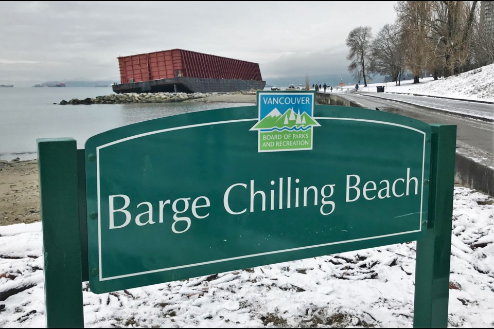 The sign at the barge placed by the Vancouver Board of Parks and Recreation was painted over with Iy̓el̓shn, the Squamish name for the beach, but has been since cleaned.