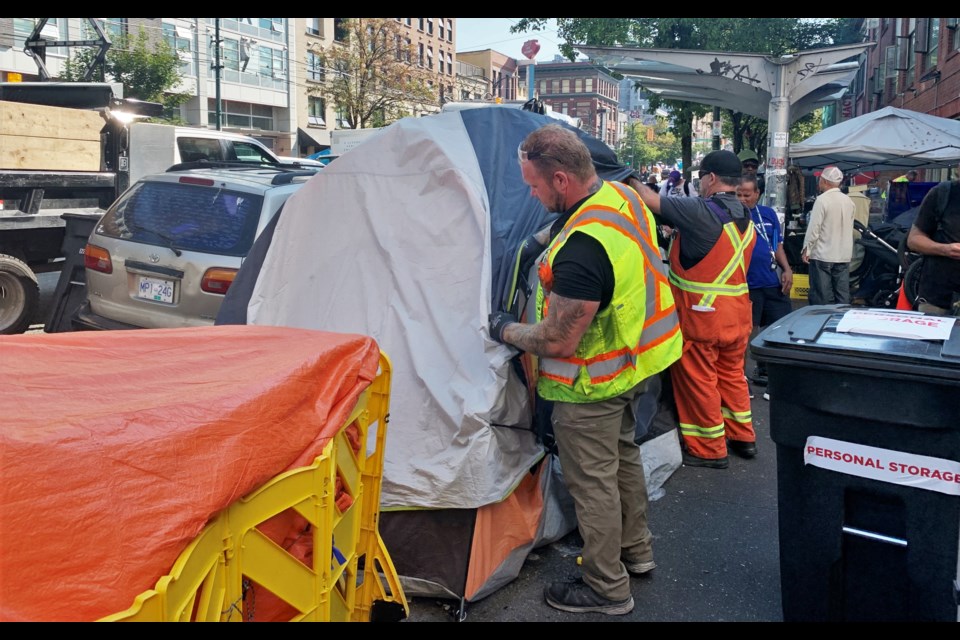 City crews remove tents in Vancouver's Downtown Eastside on Aug. 24, 2022.