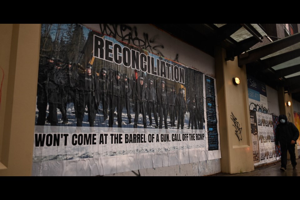 One poster is at the intersection of Main and Union Street in Vancouver and shows a photo of dozens of armed RCMP on Wet’suwet’en territory.