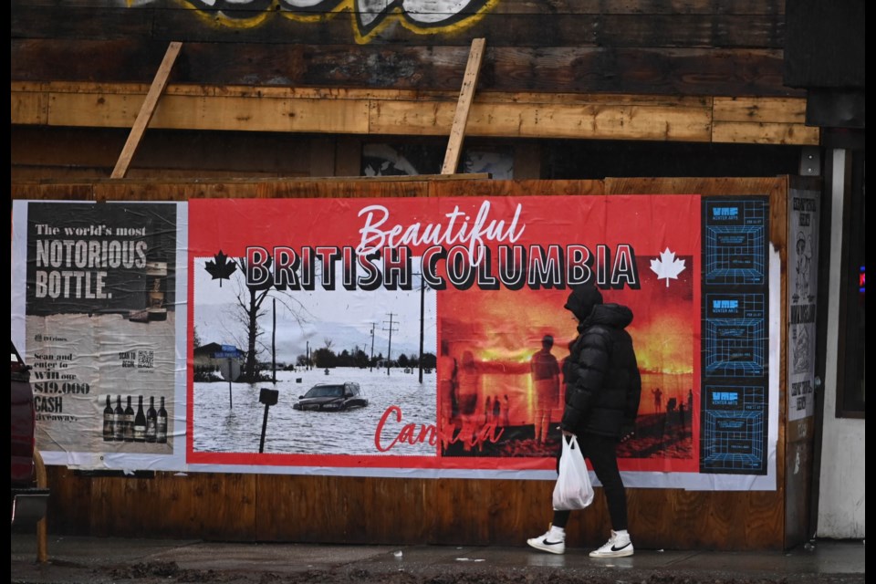 A second poster at the intersection of Hastings and Nanaimo in Vancouver juxtaposes the province's slogan, “Beautiful British Columbia,” with images of B.C.'s recent floods and wildfires. 