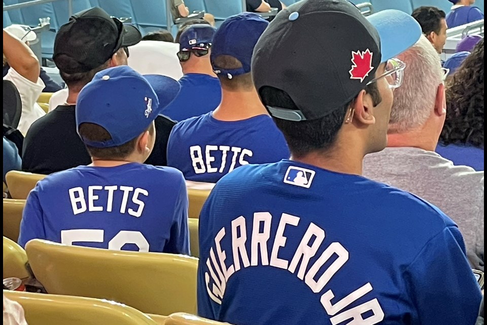 Fans cheering on the Toronto Blue Jays and the Los Angeles Dodgers at Dodger Stadium