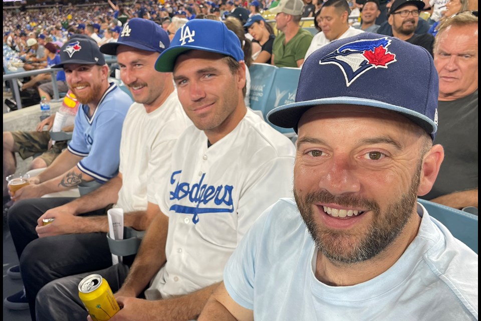 A group of friends with various MLB team allegiances attend a Blue Jays at Dodgers game in Los Angeles