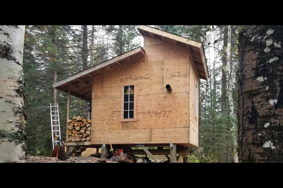 This off-grid recreational property listed for sale near Prince George, B.C. has a small, unfinished structure on it