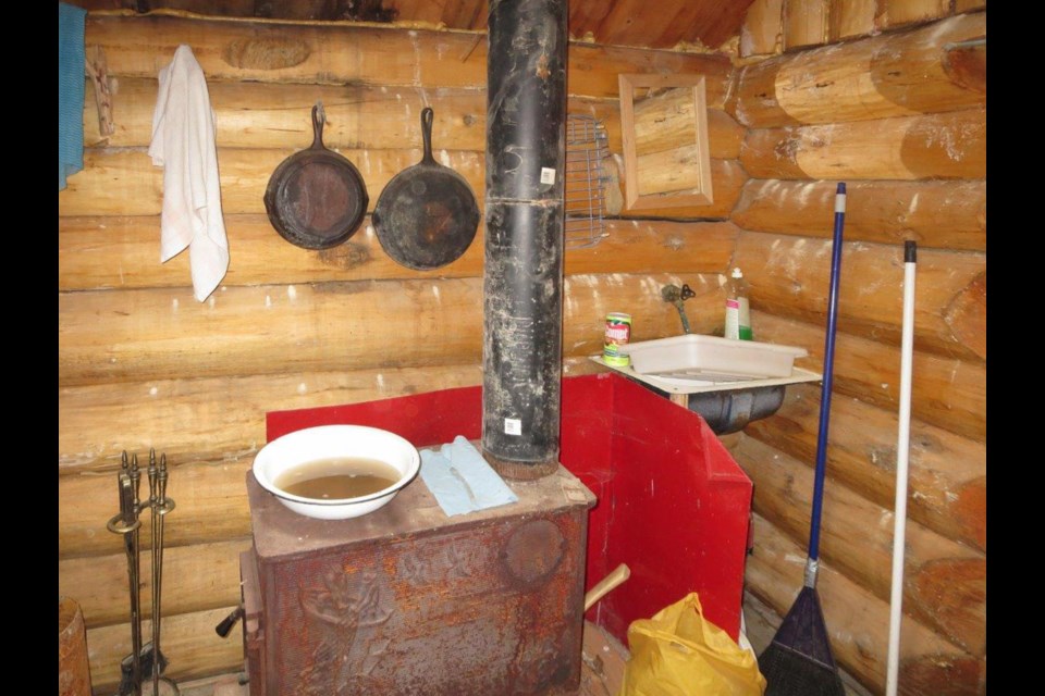 A murky bowl of water on the stove of the cabin on the Taku River may or may not be included