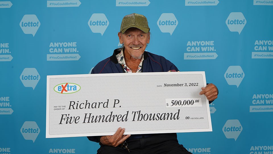 Richard Prest with his $500,000 cheque after a big win on the Extra.