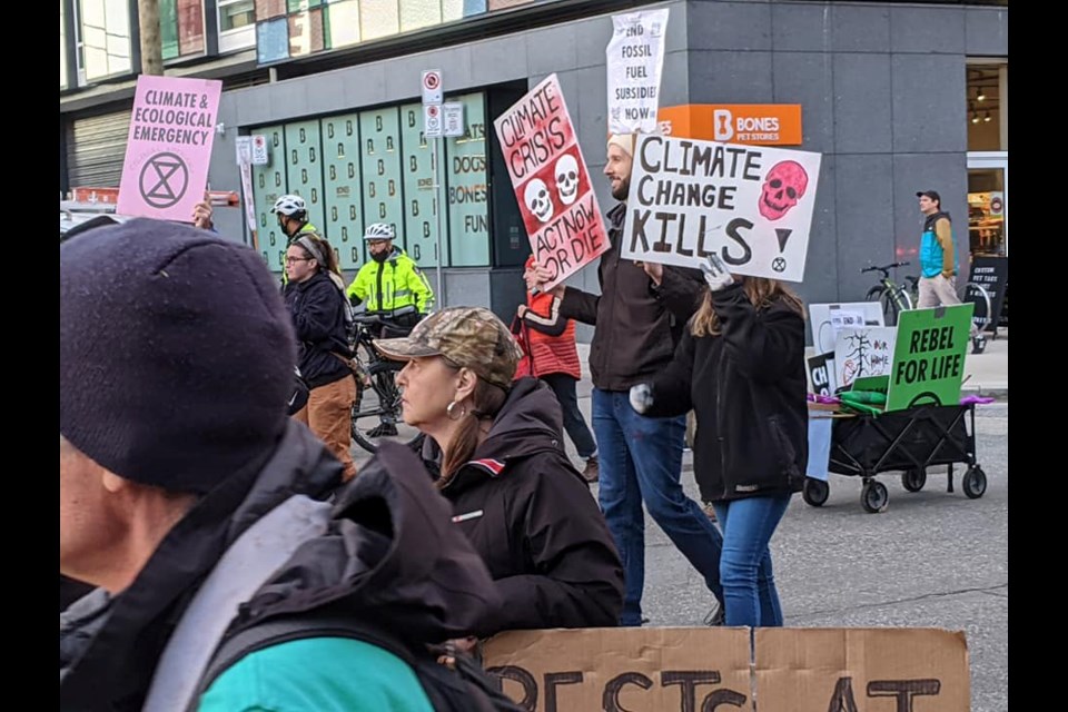 Protestors with Extinction Rebellion Vancouver locked themselves into a device at the intersection of Burrard and Pacific in downtown Vancouver.