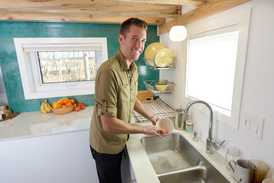 Kenton Zerbin shows off the kitchen in a tiny home he built.