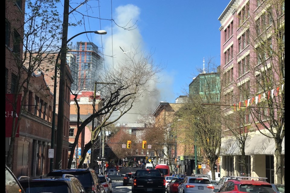 Police are advising drivers to avoid Vancouver's Gastown area due to three-alarm fire that is causing smoke to fill the sky on April 11, 2022.