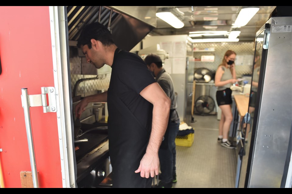 Jorge Tuane hard at work in the 8bite food trailer.