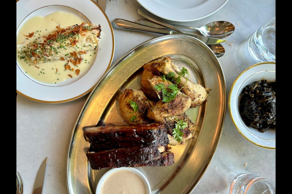 Ribs and roasted chicken with Alabama BBQ sauce are joined by sides of spicy collard greens and cabbage in a creamy cheese sauce at Say Mercy!, one of 16 鶹ýӳrestaurants on the Michelin Guide's list of value-driven Bib Gourmand spots. The restaurant announced in October it would close permanently on Nov. 2, 2024.