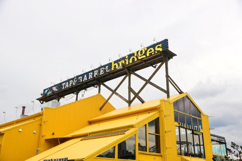 The bright yellow exterior of Bridges restaurant remains, but the sign has changed a little.