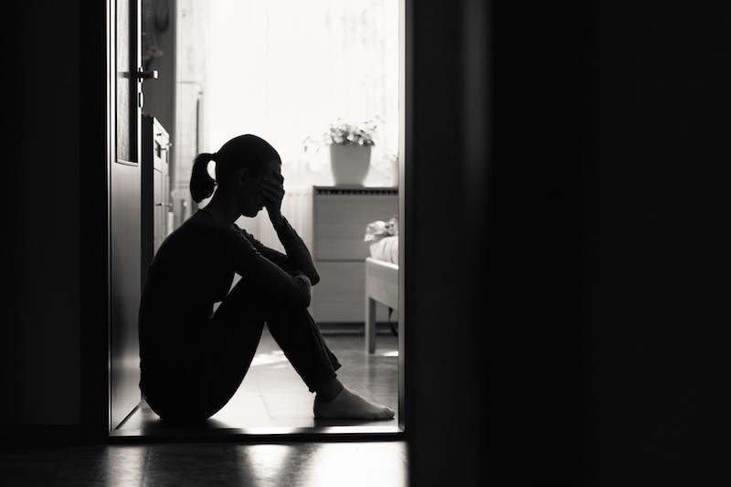 grieving-woman-sitting-alone-sad