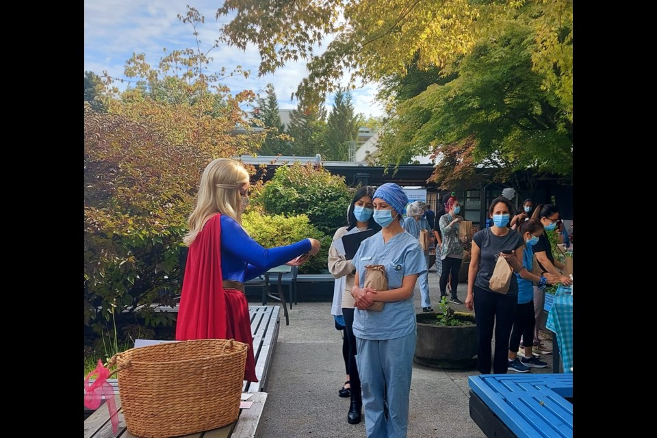 The letters were handed out by actor Kristi Provan from Pacific Fairytales portraying Supergirl.