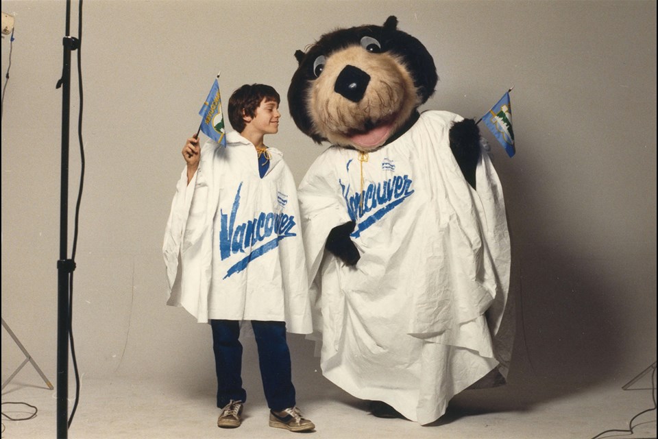 Tillicum the sea otter celebrating Vancouver's centennial in a branded Vancouver rain poncho - 2011-010.2395