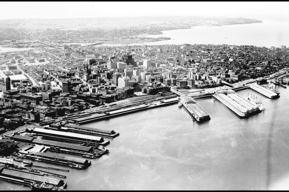 Downtown Vancouver in 1930, looking southeast from (above) the Burrard Inlet. In the foreground on the right are piers at the bottom of Howe and Burrard streets. On the left is what would become (part) the Port of Vancouver's freighter facility. The city's core is now dominated by residential towers and skyscrapers, but, at the time, the second Hotel Vancouver is the largest building, with the Vancouver Block towering nearby. What is now Waterfront Station can be seen near the middle of the photo (next to the Nabob sign).
Reference code: AM1495-: CVA 1495-10