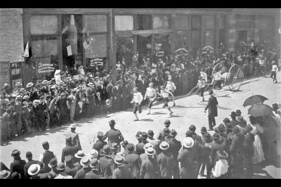 This 1893 photo shows the fire brigade demonstrating to locals how the two-wheeled handcarts work. Reference code: AM54-S4-: FD P43