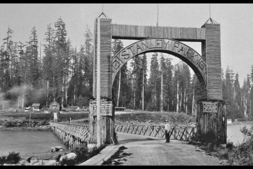 In this photo, Stanley Park may not even (officially) be one year old yet. The 1889 photo shows a man standing under the original entrance to the park, which was a gate made using the stumps of two great trees, leading to a bridge over the water (before Lost Lagoon was created). Several small buildings can be seen in the park.
Reference code: AM1576-S6-12-F47-: 2011-010.1782