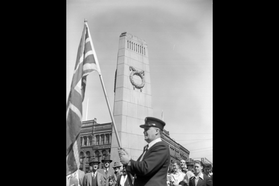 The Victory Square cenotaph and part of the Flack Block during celebrations on Victory in Europe Day on May 7, 1945. (AM1545-S3-: CVA 586-3839)
