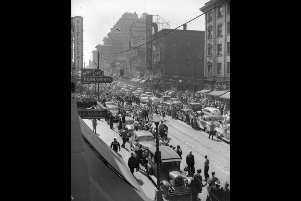 The west side of Granville Street at Dunsmuir Street including the second Hotel Vancouver in the background on May 7, 1945. (AM1545-S3-: CVA 586-3844)
