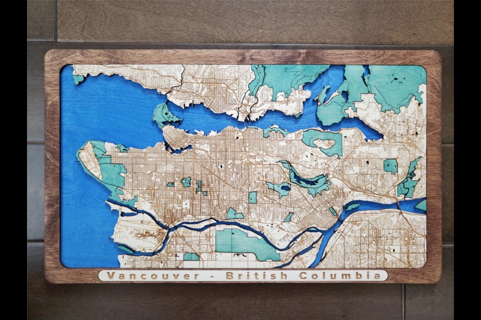 The wooden map of Vancouver has two layers, one for land and one for sea.