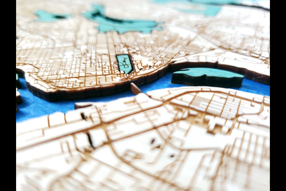 The wooden map of Vancouver has two layers, one for land and one for sea.