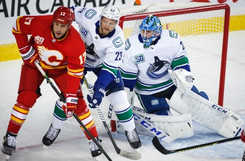 milan-lucic-and-alex-edler-battle-for-position-in-front-of-jacob-markstrom