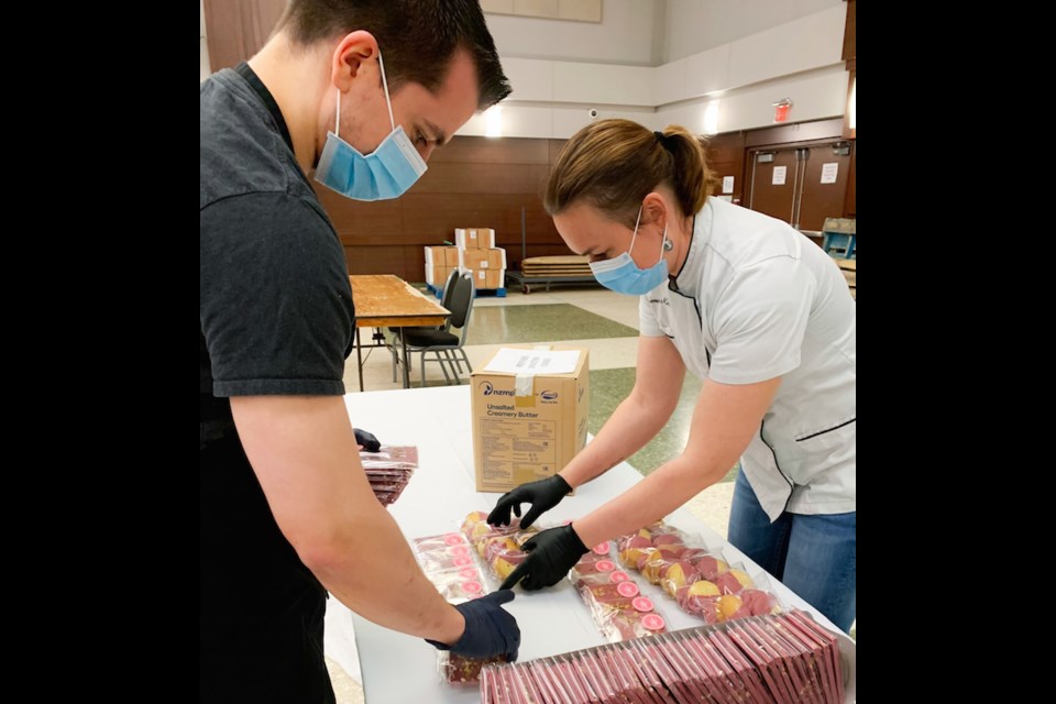 Elena Krasnova of Mon Paris prepares packages of treats for families through LunchLAB. Photo courtesy Mon Paris Patisserie