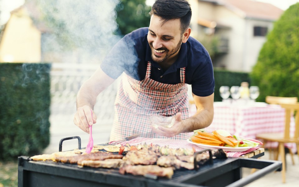 chicken-being-flipped-man-smiling-apron