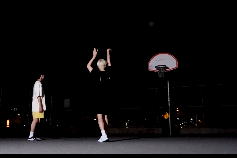 Joshua and Seungkwan of K pop group Seventeen play basketball in downtown Vancouver.
