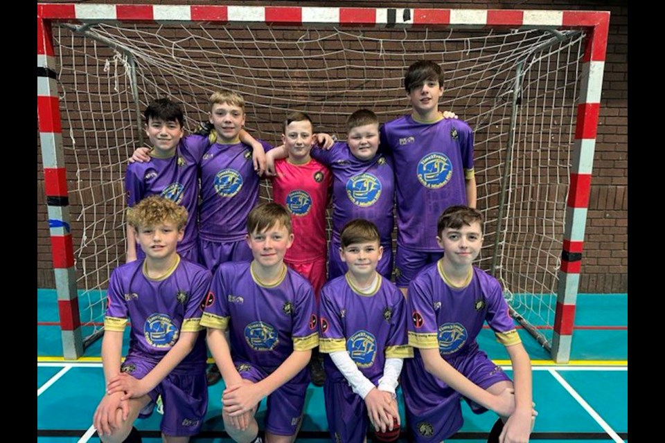 The U-12 futsal team FC United of Wrexham received their purple kits after Ryan Reynolds made a surprise donation to their fundraiser. 