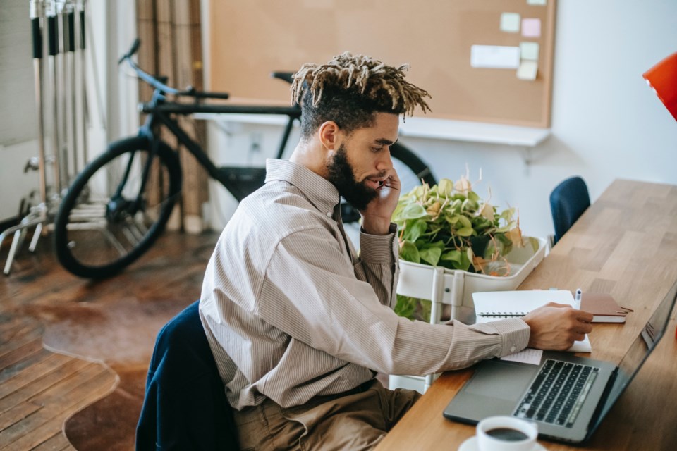 man-on-phone-computer_pexels