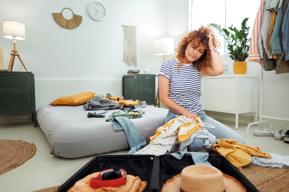 person-packing-suitcase
