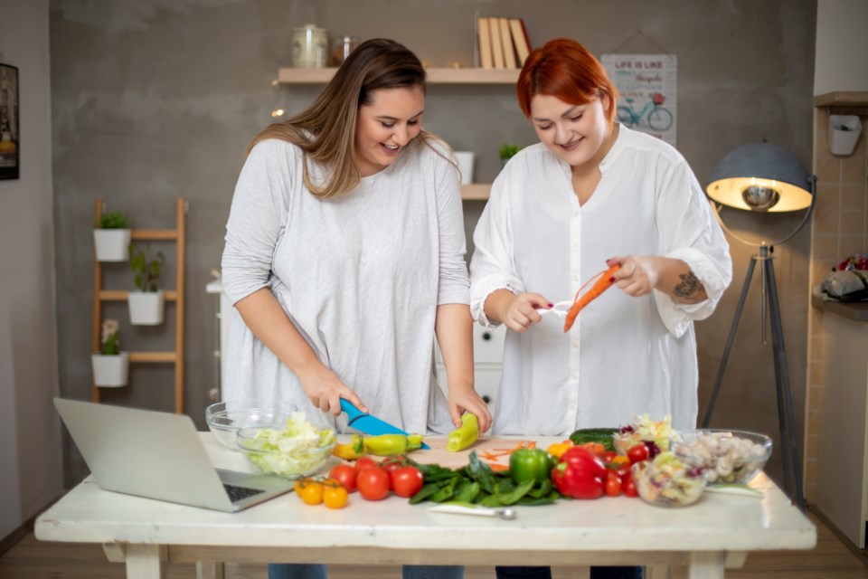 plus-size-women-making-salad-gettyimages