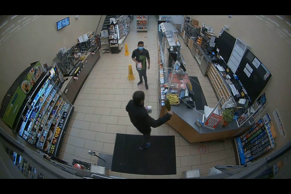 A man with a bottle threatens a store clerk.