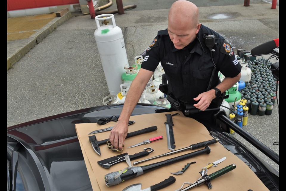 Cst. Steve Addison with weapons recovered by police during one night shift in the DTES.