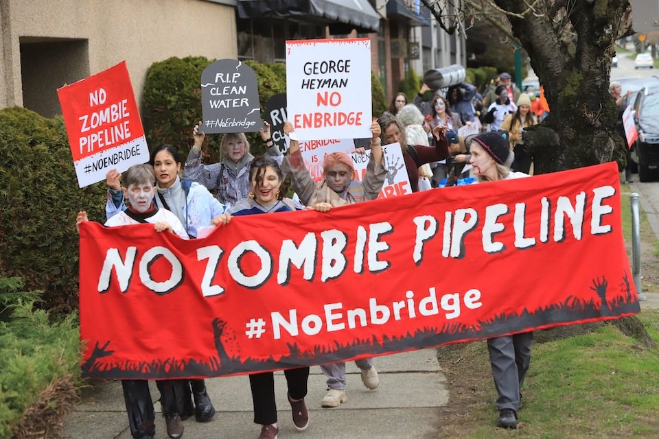 At the front of the march, the group carried a large, bright-red banner that read: "No zombie pipeline #Enbridge."