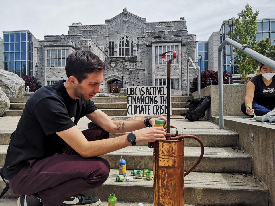 Save Old Growth protester painting stairs at UBC