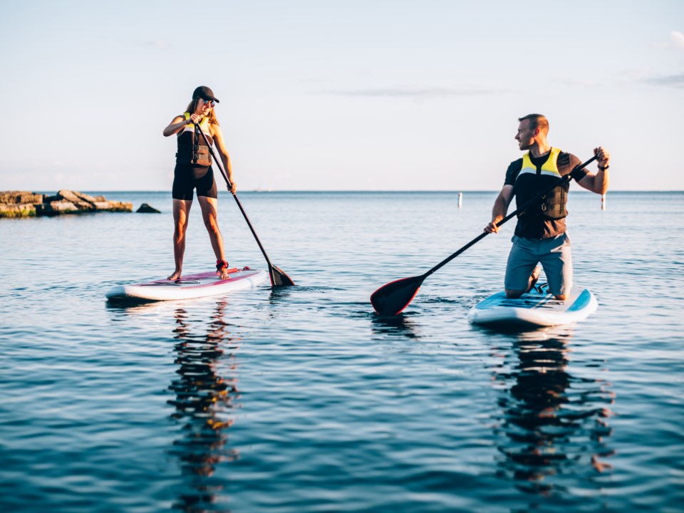 couple-paddleboarding-on-lake-gettyimages