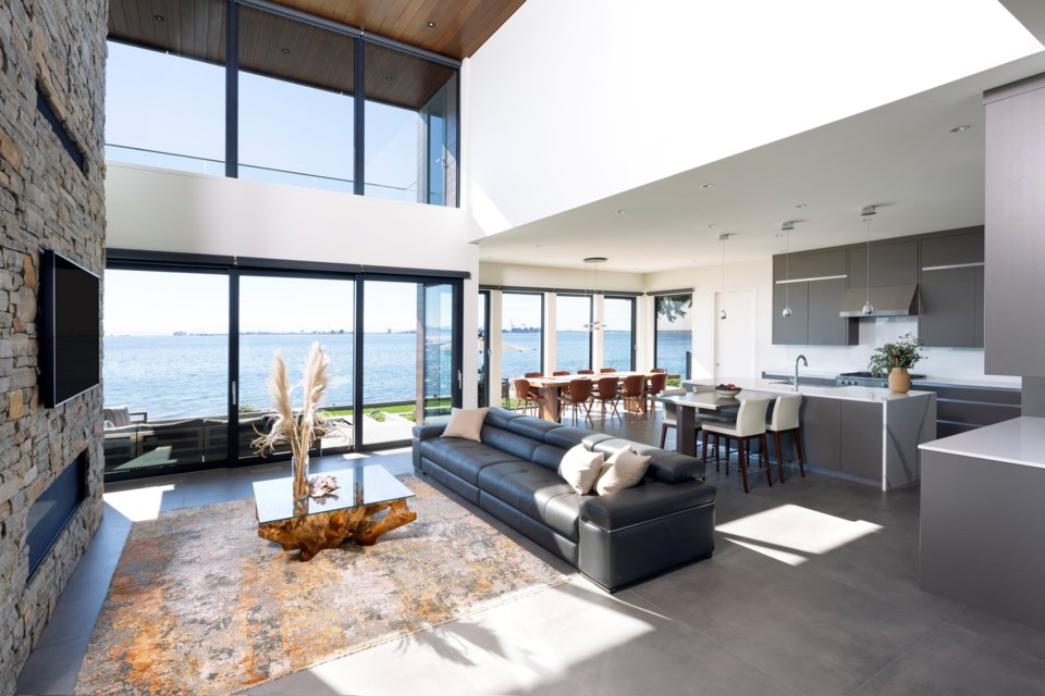 The addition of a four-storey fully enclosed elevator connects the beach level home to the hillside garage in this stunning west coast modern Tsawwassen new custom home.