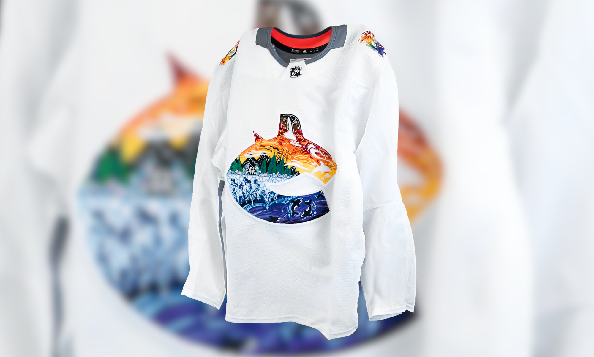 Vancouver Canucks' J.T. Miller wears a pride-themed warmup jersey