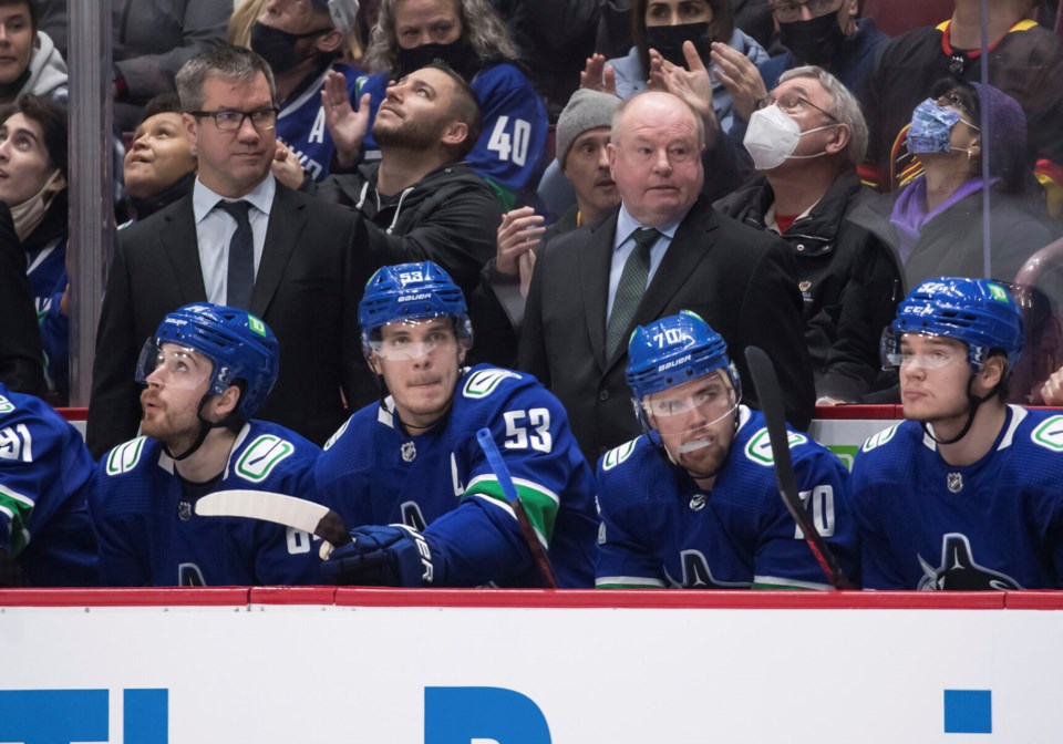 boudreau and walker behind canucks bench darryl dyck cp