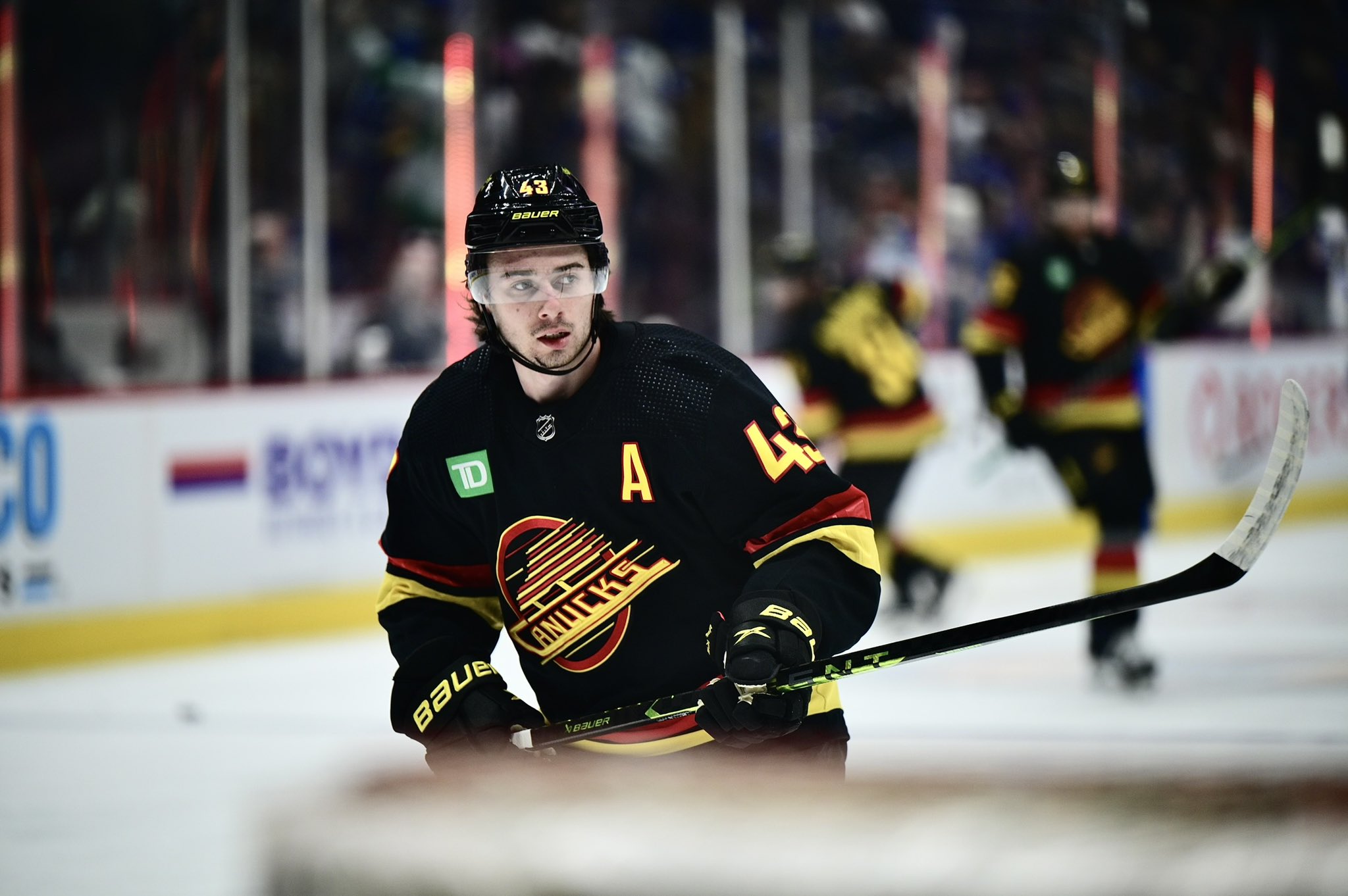 Vancouver Canucks' Quinn Hughes (43) fights for control of the