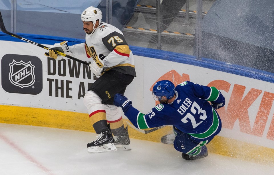 Ryan Reaves hits Alex Edler, Jason Franson CP