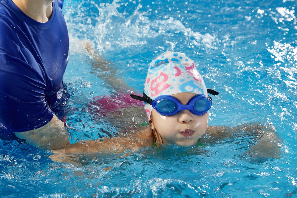 child-swimming-lessons-instructor-pool-getty