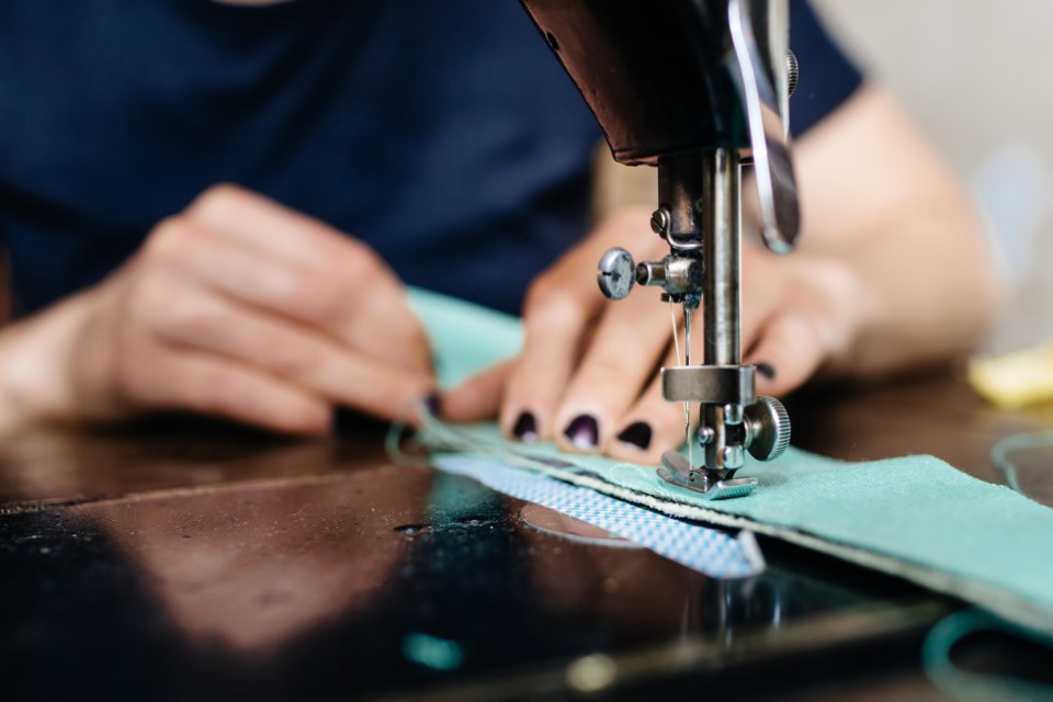 Close up on hands sewing