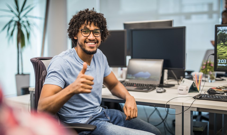 happy-man-at-work-computers-desk