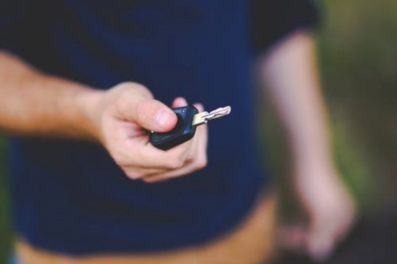 man-holding-car-key